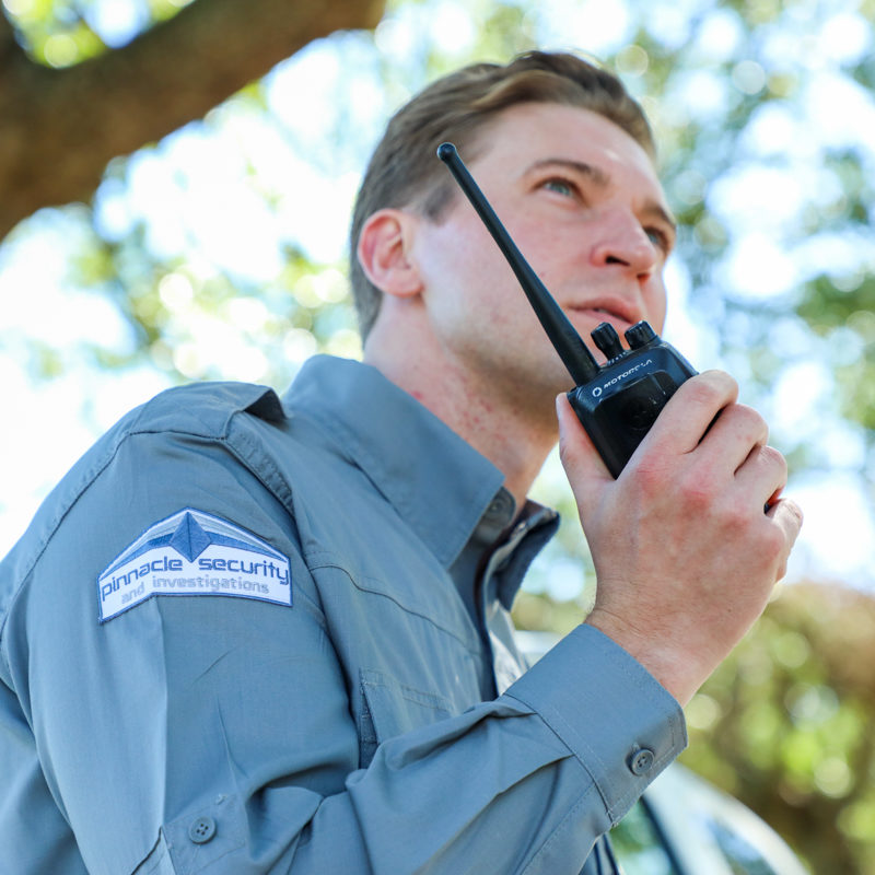 Pinnacle Security officer uses walkie talkie