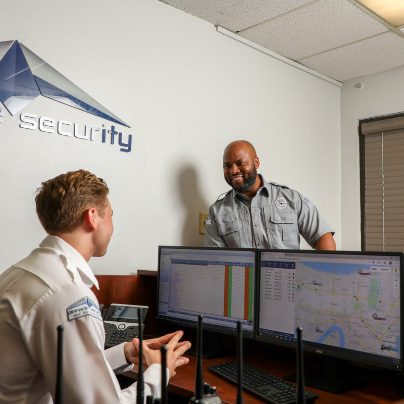 Respect - Pinnacle Security officers confer over virtual monitoring screens at the company headquarters